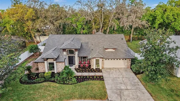 an aerial view of a house with a yard