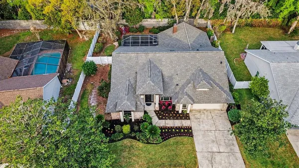 an aerial view of a house with garden space and street view