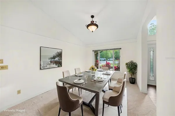 a dining room with furniture and window