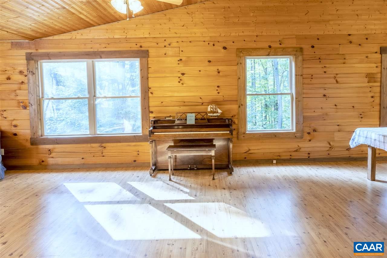 703 George James Loop Radiant, VA 22732 - Photo 14 of 48 a living room with a floor to ceiling window and wooden floor