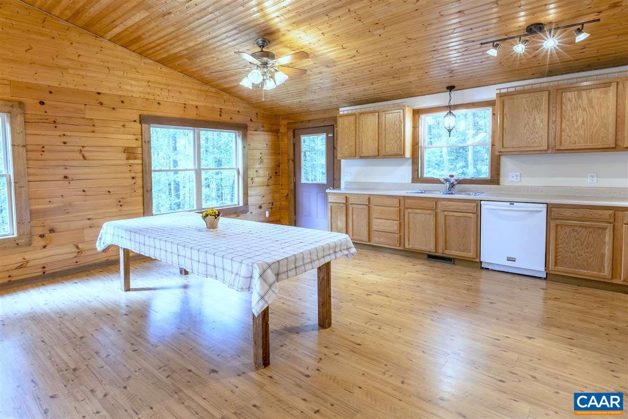 703 George James Loop Radiant, VA 22732 - Photo 5 of 48 a kitchen with stainless steel appliances granite countertop a stove a sink a refrigerator dining table and chairs with wooden floor