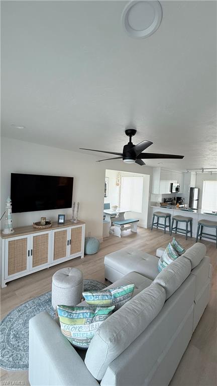 2235 San Marco Road, Unit 5204 Marco Island, FL 34145 - Photo 25 of 34 Open-concept living space featuring wood-finish flooring and a contemporary black ceiling fan