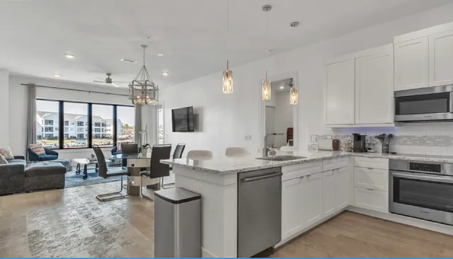 a open kitchen with stainless steel appliances granite countertop a sink and cabinets