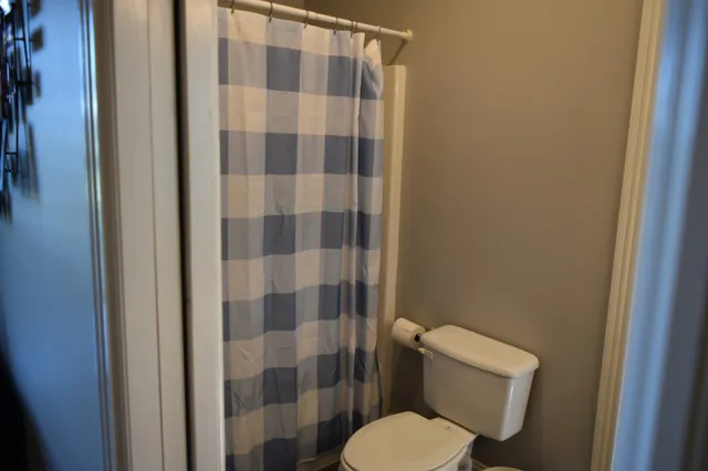 a living room with furniture a chandelier and a flat screen tv