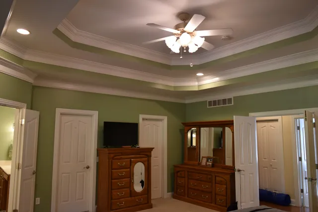 a kitchen with a table chairs sink and cabinets