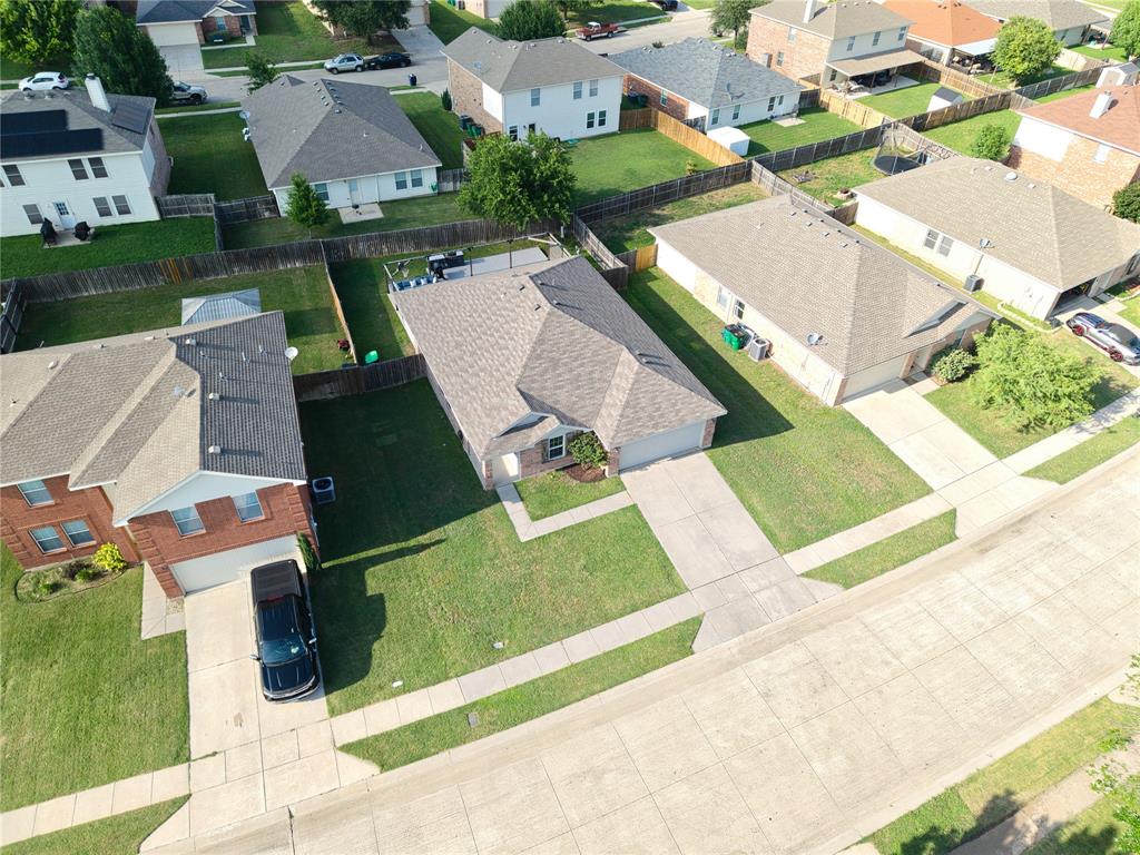 12724 Carpenter Lane Rhome, TX 76078 - Photo 29 of 37 Aerial perspective showcasing a residential street with uniform concrete sidewalks and driveways
