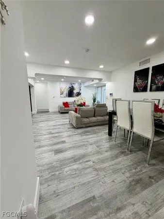 a bed sitting in a bedroom next to a white cabinet