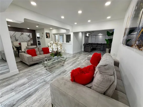a living room with furniture and wooden floor