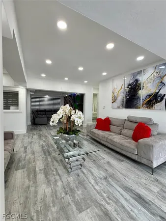 a living room with furniture and a potted plant