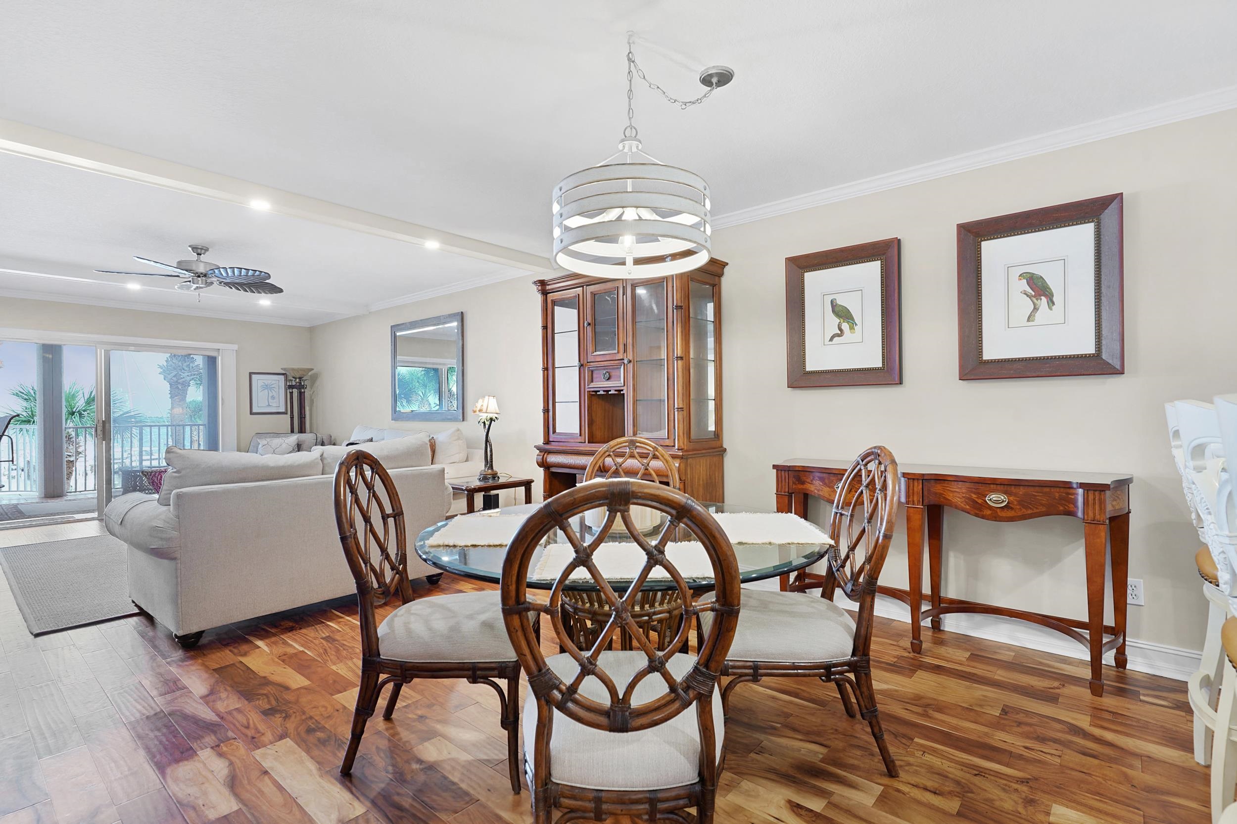 33 Comares Avenue, Unit 203 St. Augustine, FL 32080 - Photo 13 of 39 Dining space with hardwood / wood-style flooring, ceiling fan, crown molding, and a chandelier