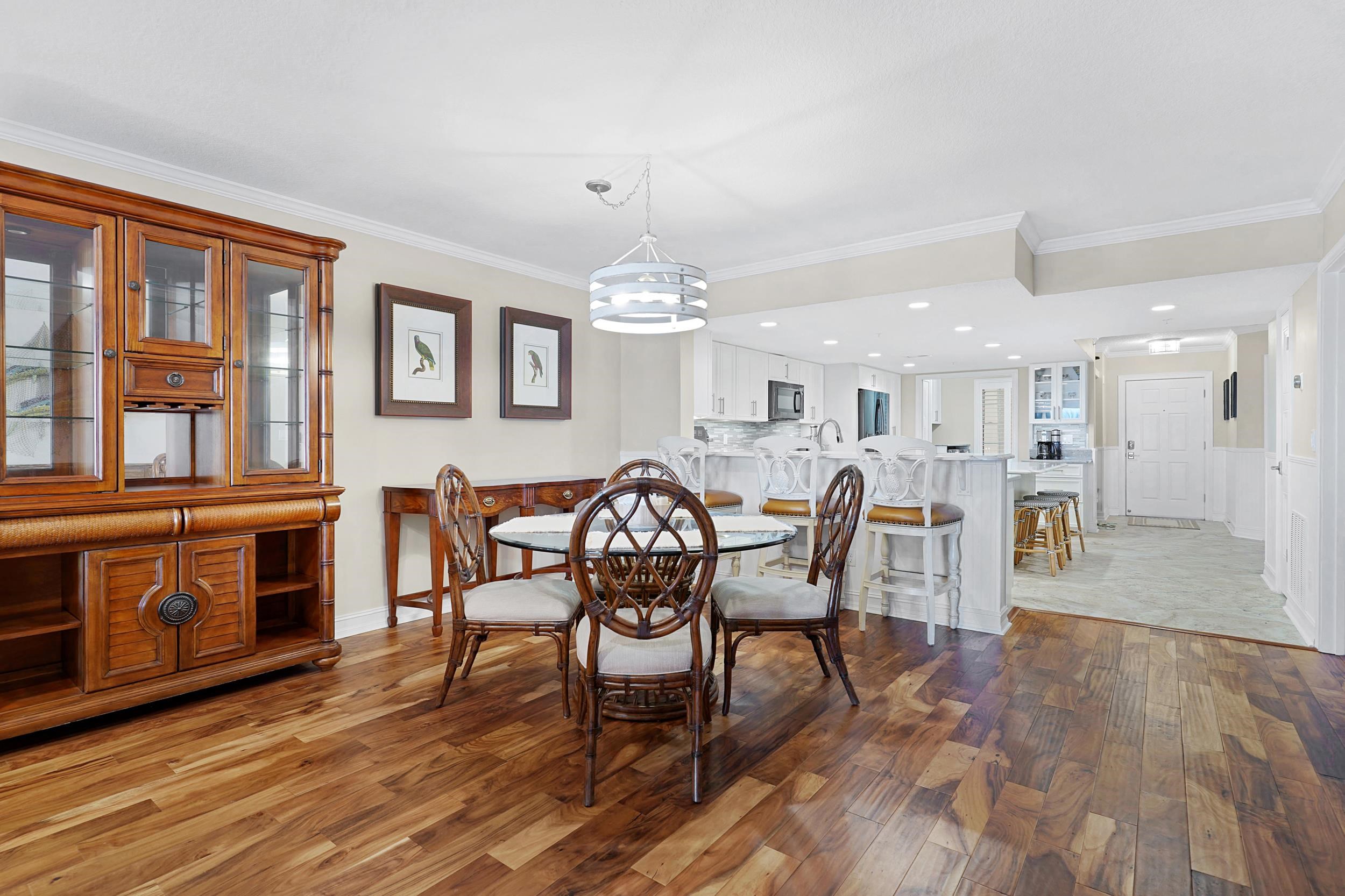 33 Comares Avenue, Unit 203 St. Augustine, FL 32080 - Photo 14 of 39 Dining room with dark wood-style flooring, recessed lighting, crown molding, and a chandelier