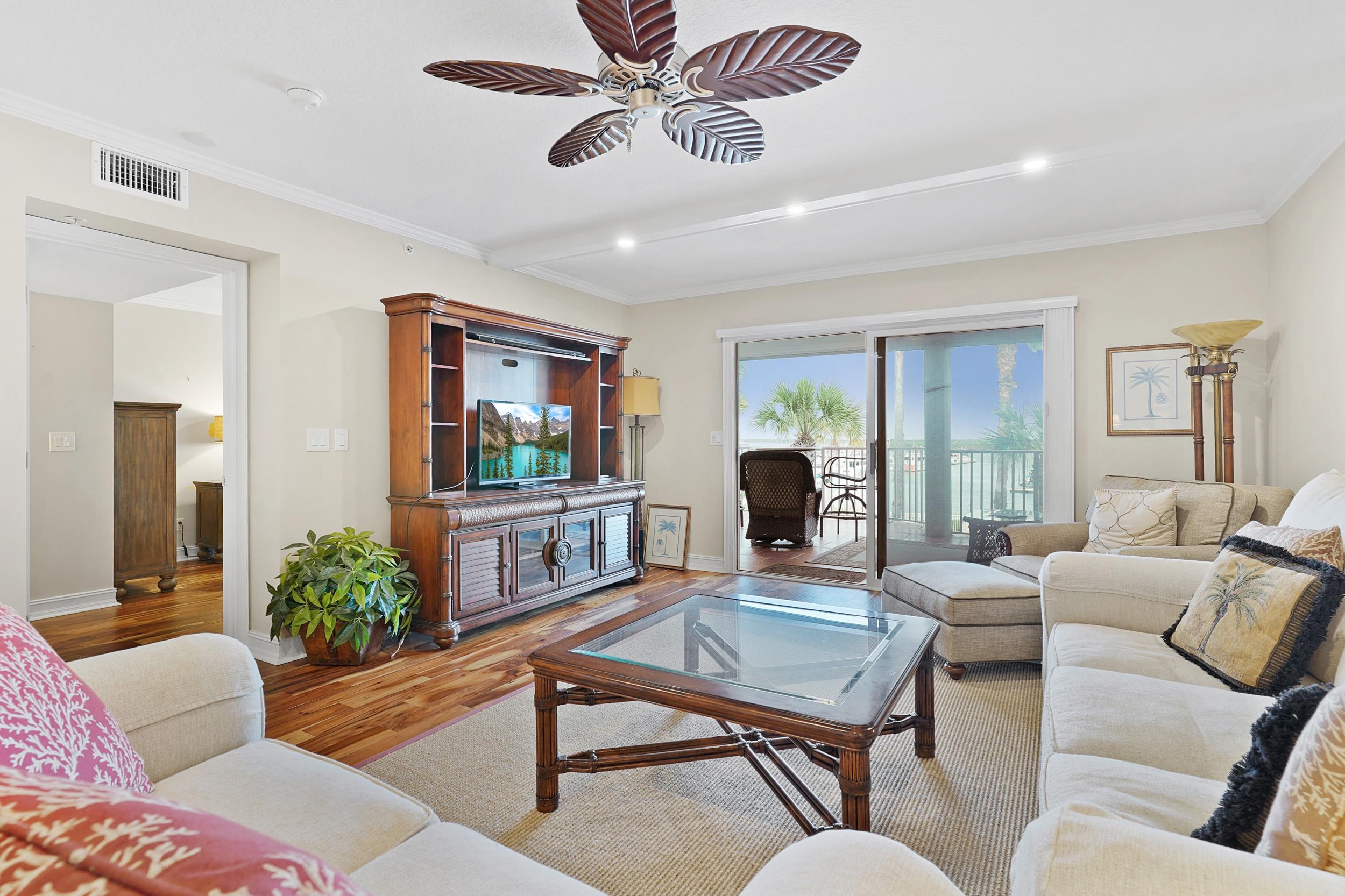 33 Comares Avenue, Unit 203 St. Augustine, FL 32080 - Photo 16 of 39 Living area featuring wood finished floors, a ceiling fan, ornamental molding, and recessed lighting