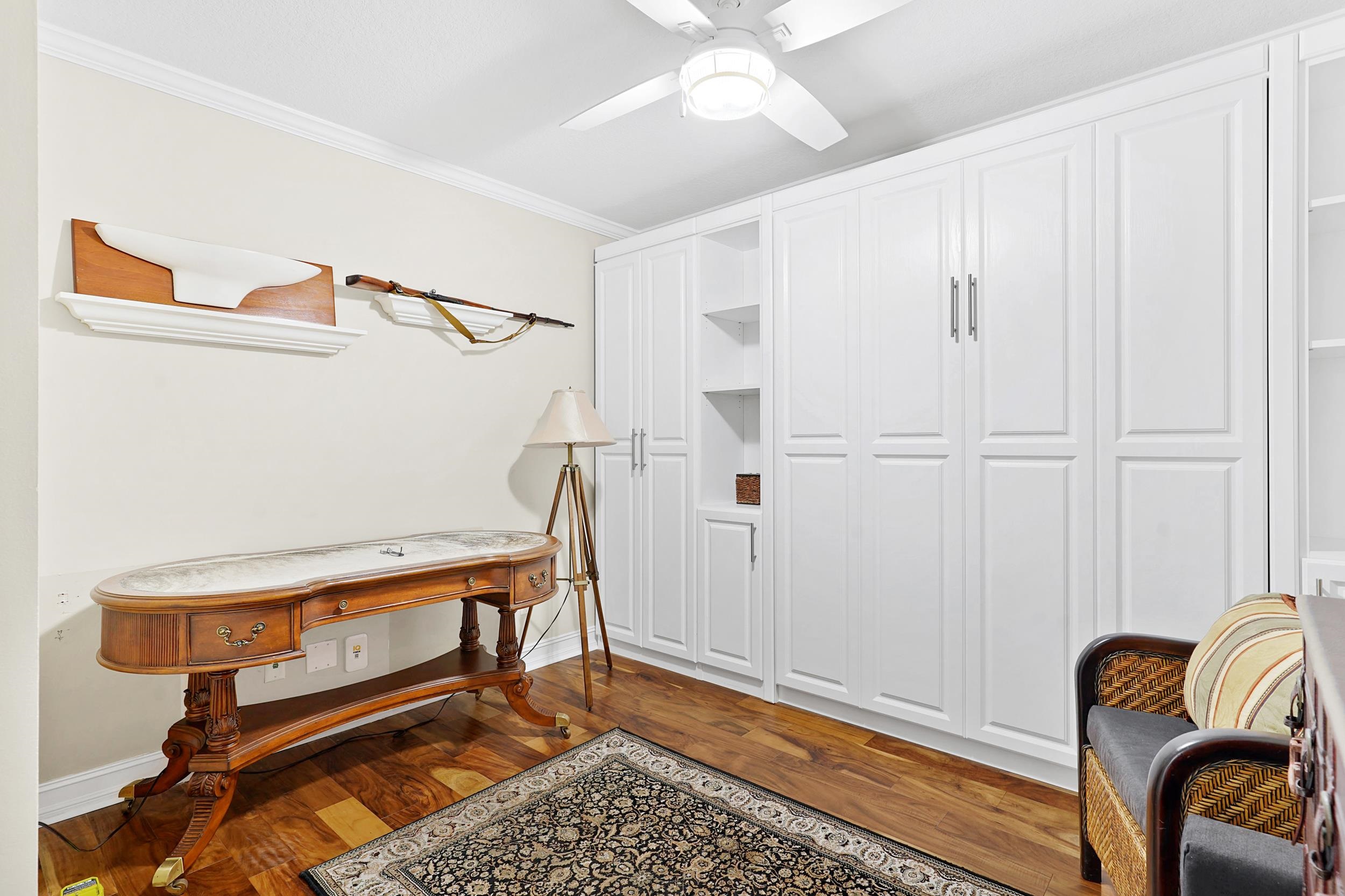 33 Comares Avenue, Unit 203 St. Augustine, FL 32080 - Photo 18 of 39 Office featuring crown molding, dark wood-style floors, and a ceiling fan