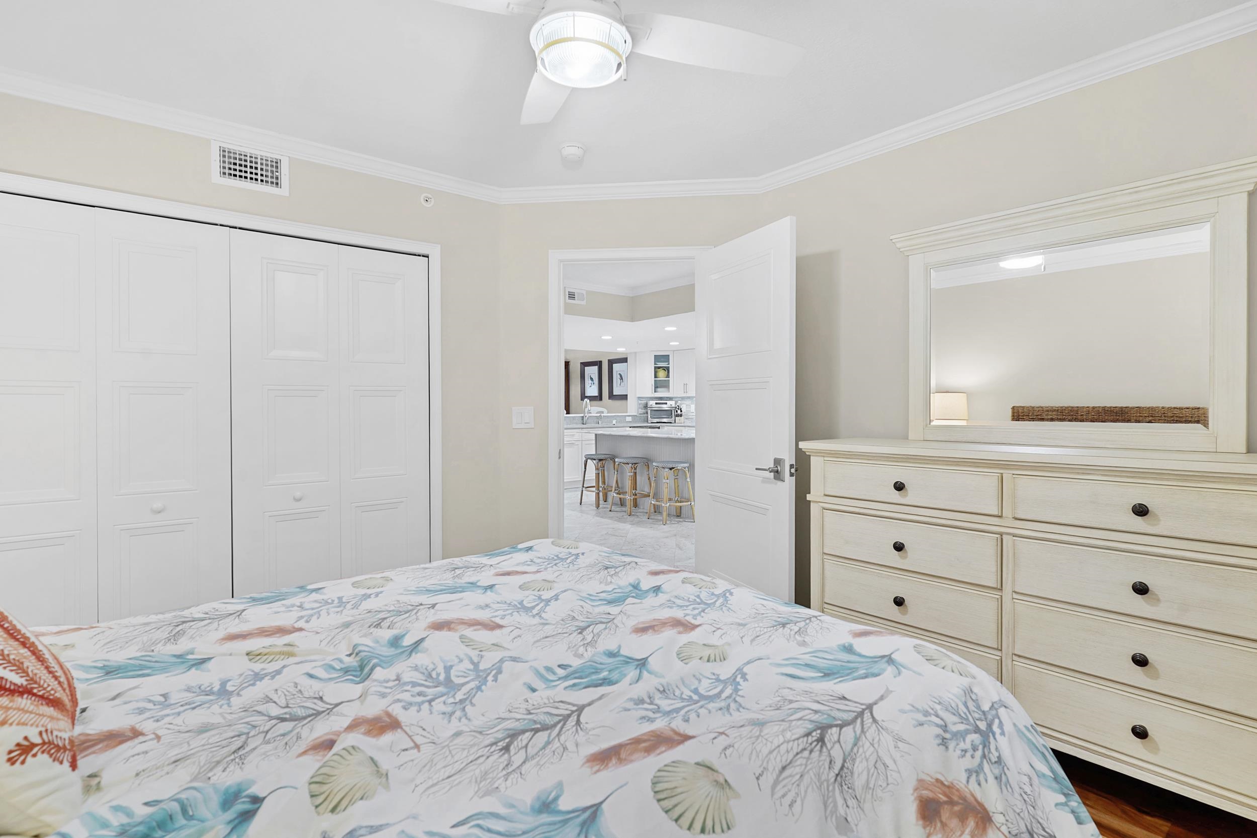 33 Comares Avenue, Unit 203 St. Augustine, FL 32080 - Photo 20 of 39 Bedroom with a closet, a ceiling fan, and ornamental molding