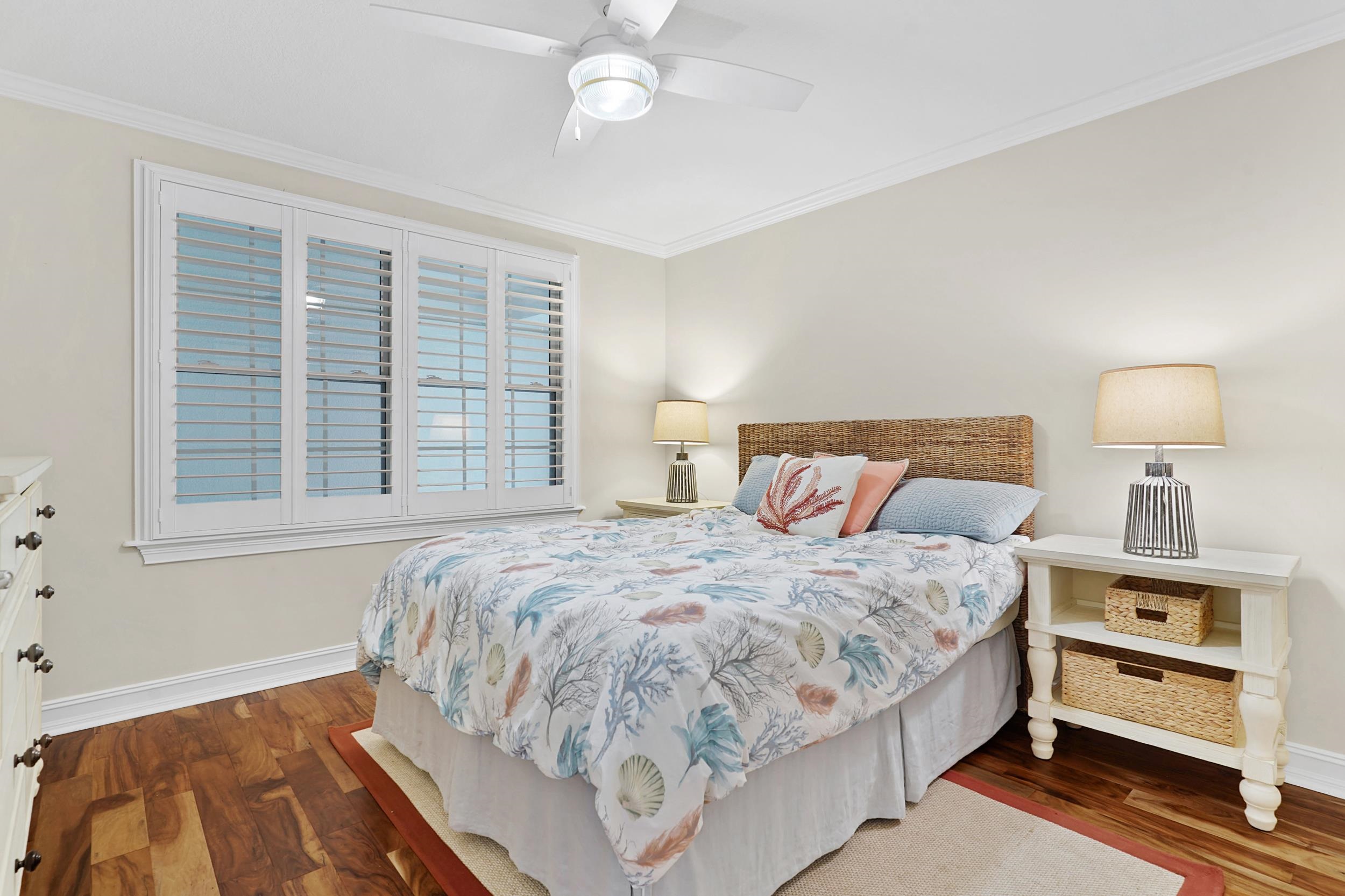 33 Comares Avenue, Unit 203 St. Augustine, FL 32080 - Photo 21 of 39 Bedroom with crown molding, dark wood-style flooring, and a ceiling fan