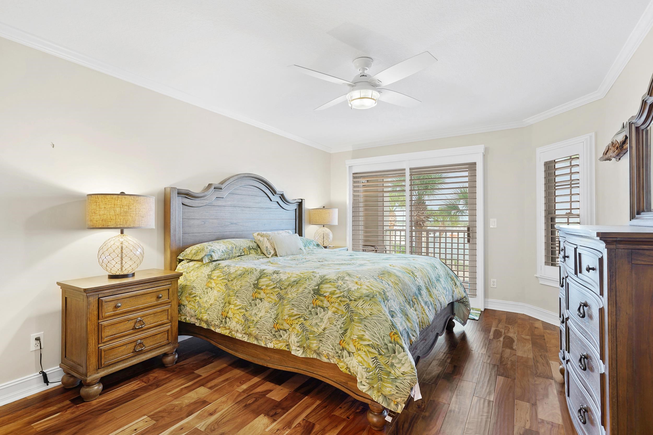 33 Comares Avenue, Unit 203 St. Augustine, FL 32080 - Photo 24 of 39 Bedroom with crown molding, a ceiling fan, dark wood finished floors, and access to outside