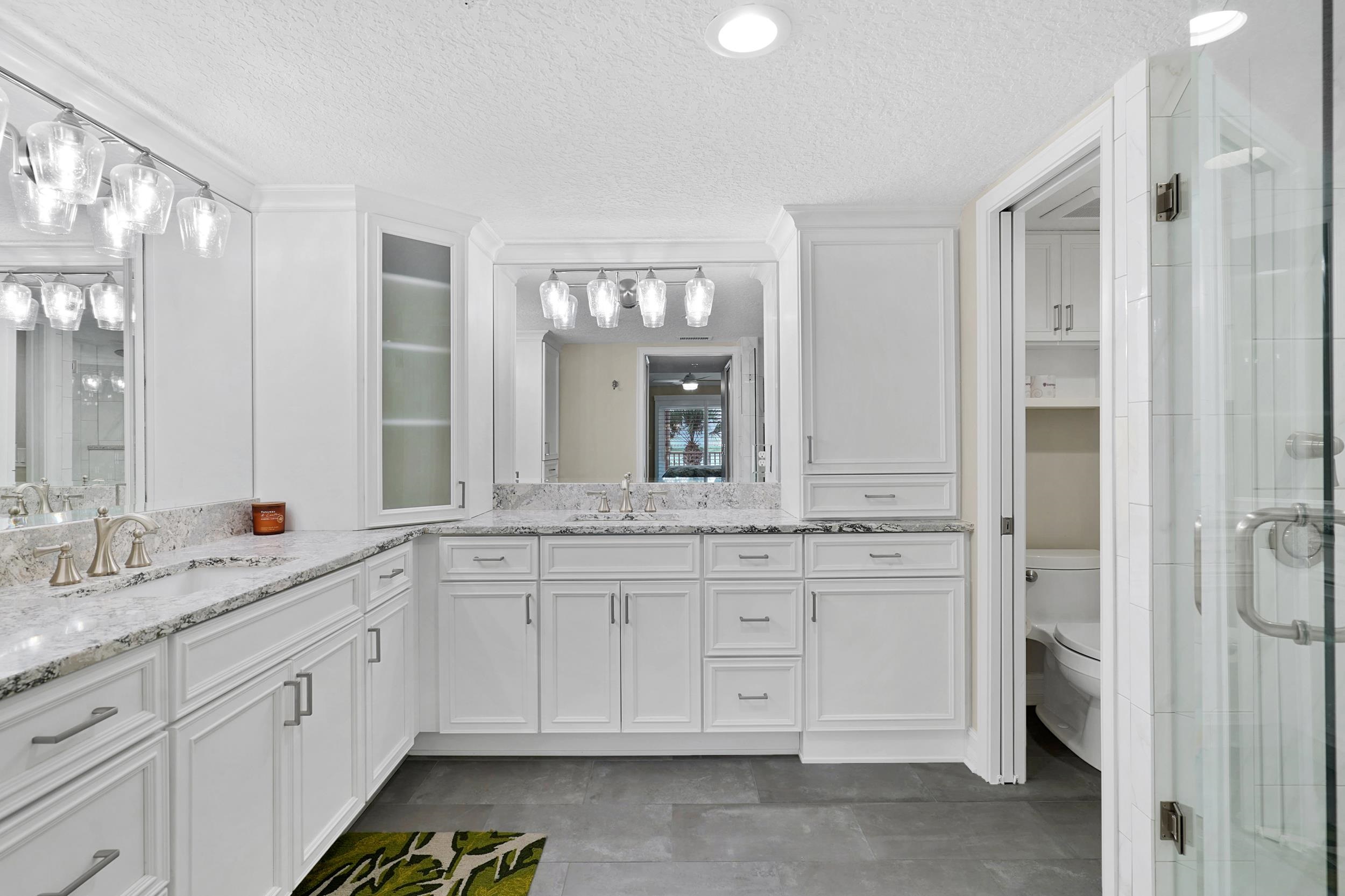33 Comares Avenue, Unit 203 St. Augustine, FL 32080 - Photo 25 of 39 Bathroom featuring a textured ceiling, vanity, and a stall shower