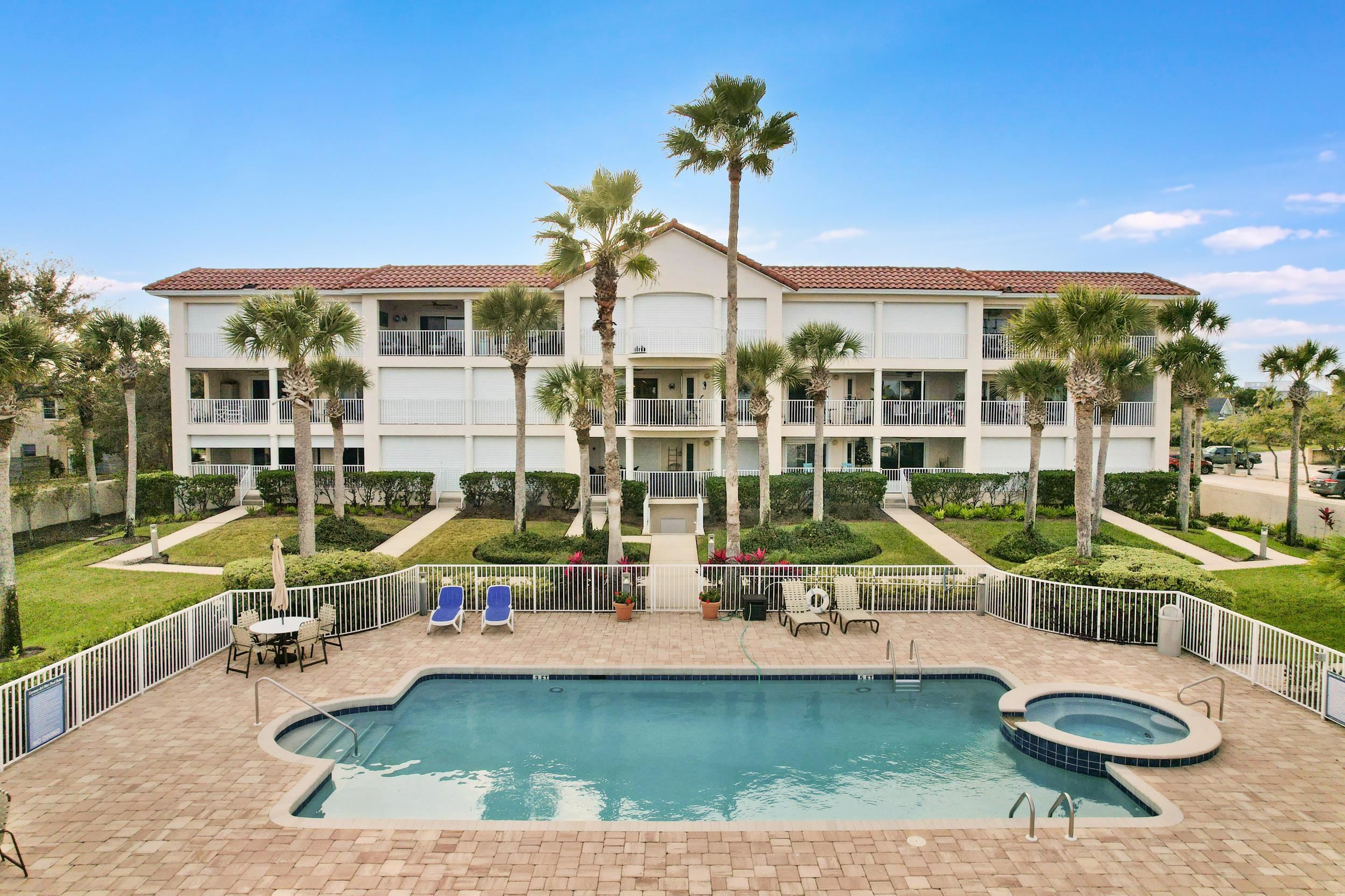33 Comares Avenue, Unit 203 St. Augustine, FL 32080 - Photo 5 of 39 View of pool with a pool with connected hot tub and a patio area