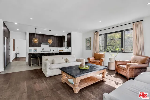 a view of a dining room with furniture a chandelier and wooden floor