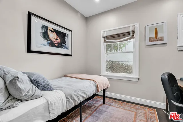 a bed room with a bed and a chair