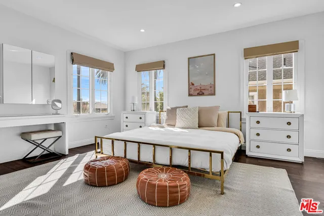 a bedroom with a large bed and a large window