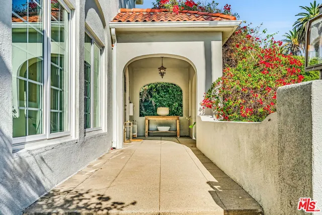 a living room with furniture a fireplace and a large window