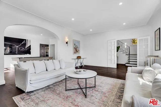 a kitchen with stainless steel appliances granite countertop a sink a stove and a refrigerator