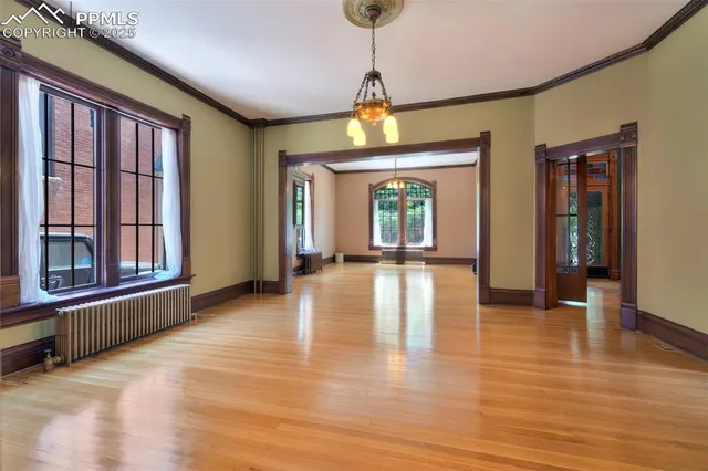 a view of an entryway with wooden floor and a front door