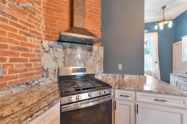 a stove top oven sitting inside of a kitchen
