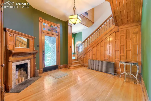 a view of entryway and hall with wooden floor