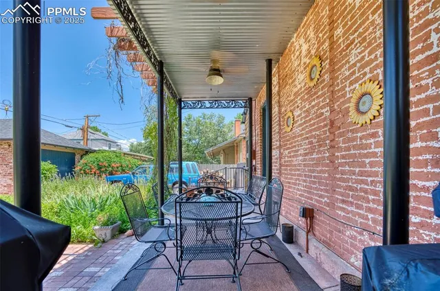 a living room filled with furniture and a potted plant
