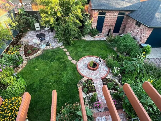 a view of backyard with swimming pool and outdoor seating