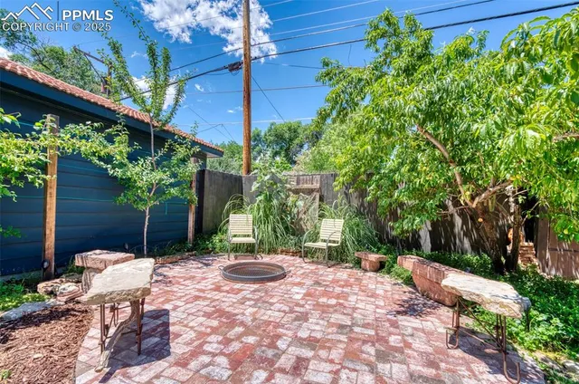 a backyard of a house with table and chairs