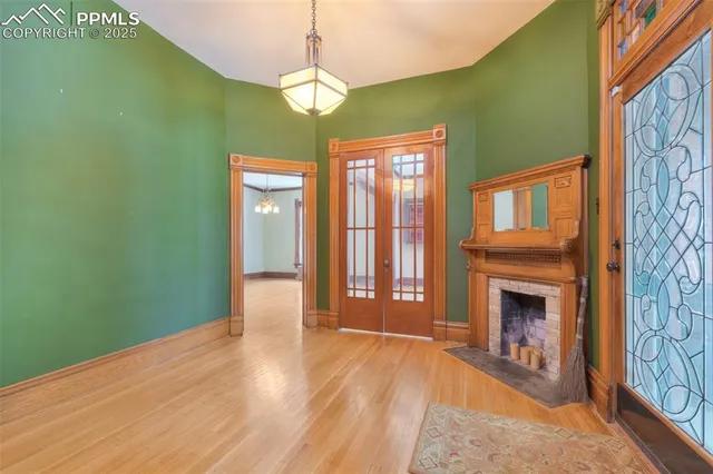 a view of an empty room with a fireplace and a window