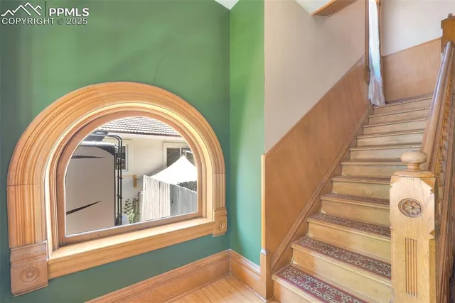 a view of a livingroom with wooden floor and white walls