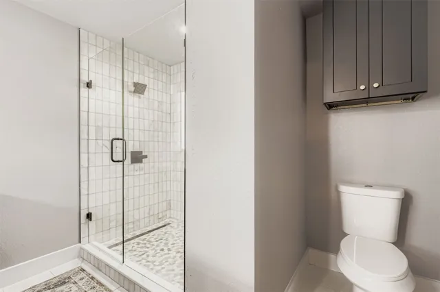 a white toilet sitting next to a bathroom sink