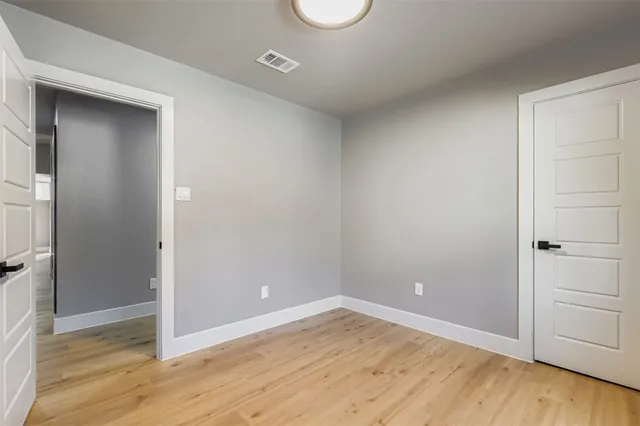 a view of a room with wooden floor