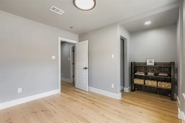 a view of a room with wooden floor