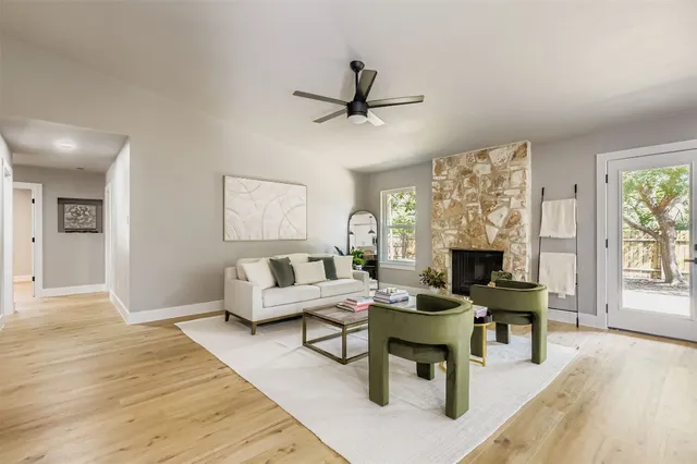 a living room with furniture a fireplace and a table