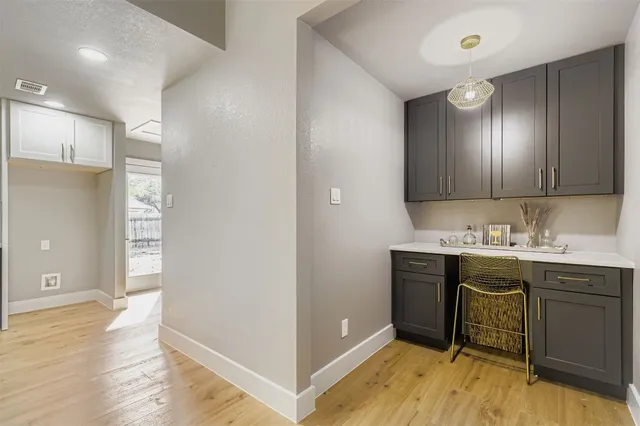 a kitchen with a sink cabinets and wooden floor
