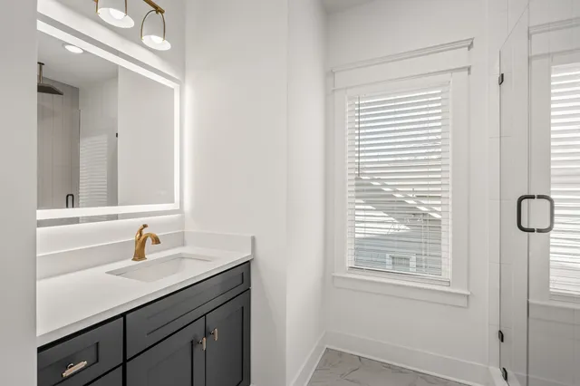 a bathroom with a sink a vanity and a mirror