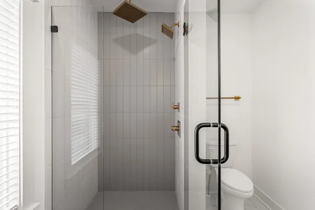 a bathroom with a shower and a sink