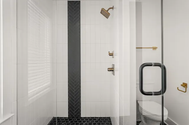 a view of a bathroom with a shower and mirror