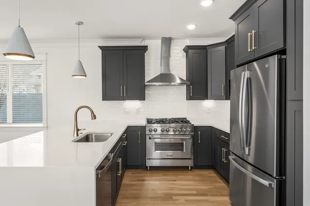 a kitchen with stainless steel appliances a refrigerator sink and stove