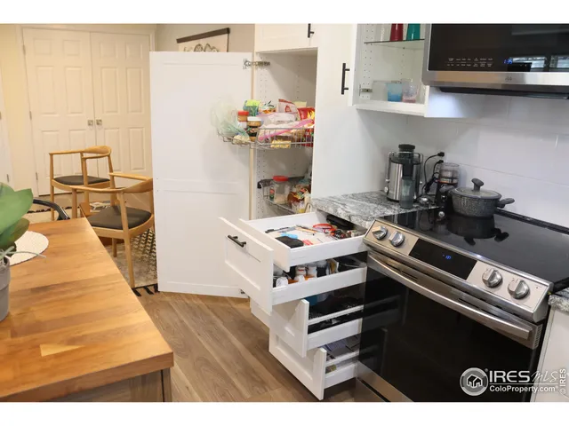 a kitchen with stainless steel appliances a stove a sink and cabinets