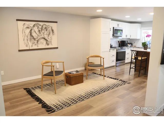 a living room with dining room and wooden floor