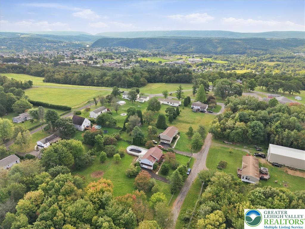 74 Swiss View Road Lehighton, PA 18235 - Photo 59 of 59 Rolling green hills and majestic mountain ridges frame this peaceful aerial countryside view.