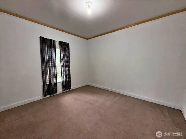 a room with a door and a shower curtain