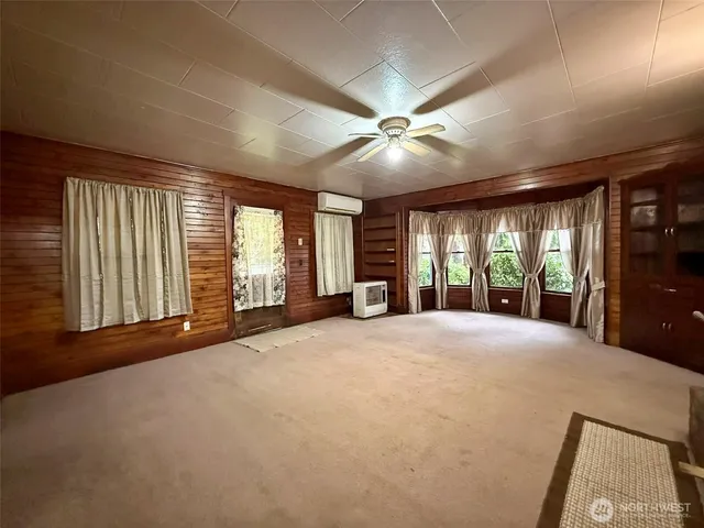 a view of an empty room with a fireplace and a large window