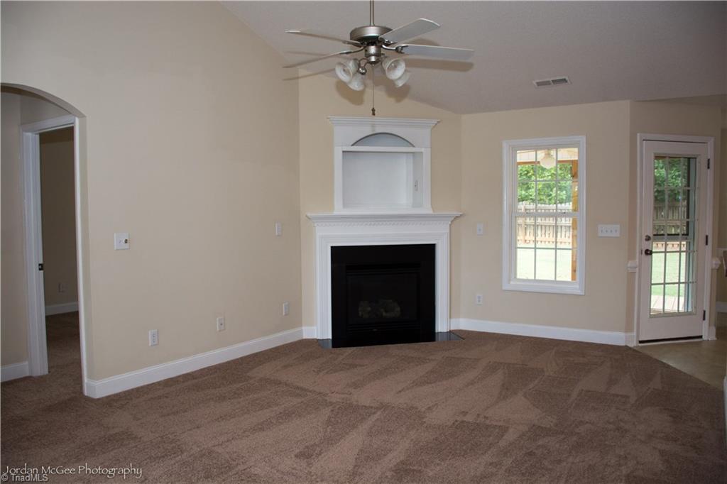 879 Ridge View Terrace Rural Hall, NC 27045 - Photo 4 of 18 Cozy living room with gas logs and brand new carpet.